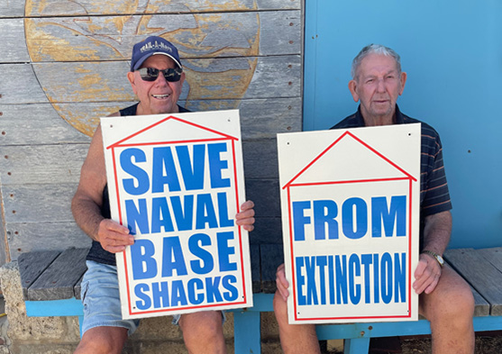 Brothers John and Kevin Nelson hold ‘Save Naval Base Shacks‘ signs they made in 2010, photo Jo Darbyshire